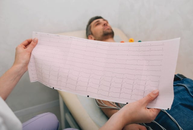 A doctor looking at the results of an electrocardiogram