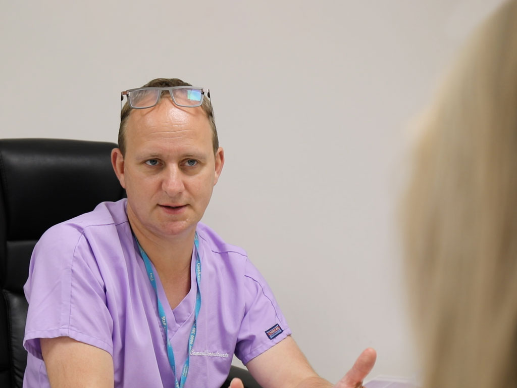 Mr Giles Davies talks to a patient