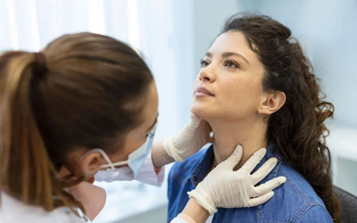 Doctor examining a patient's neck