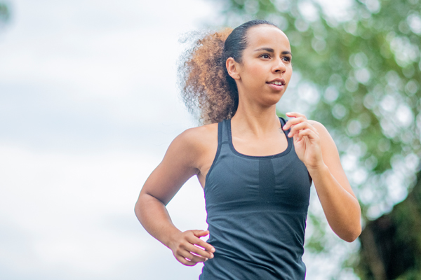 A photo of a woman running outside; ?>