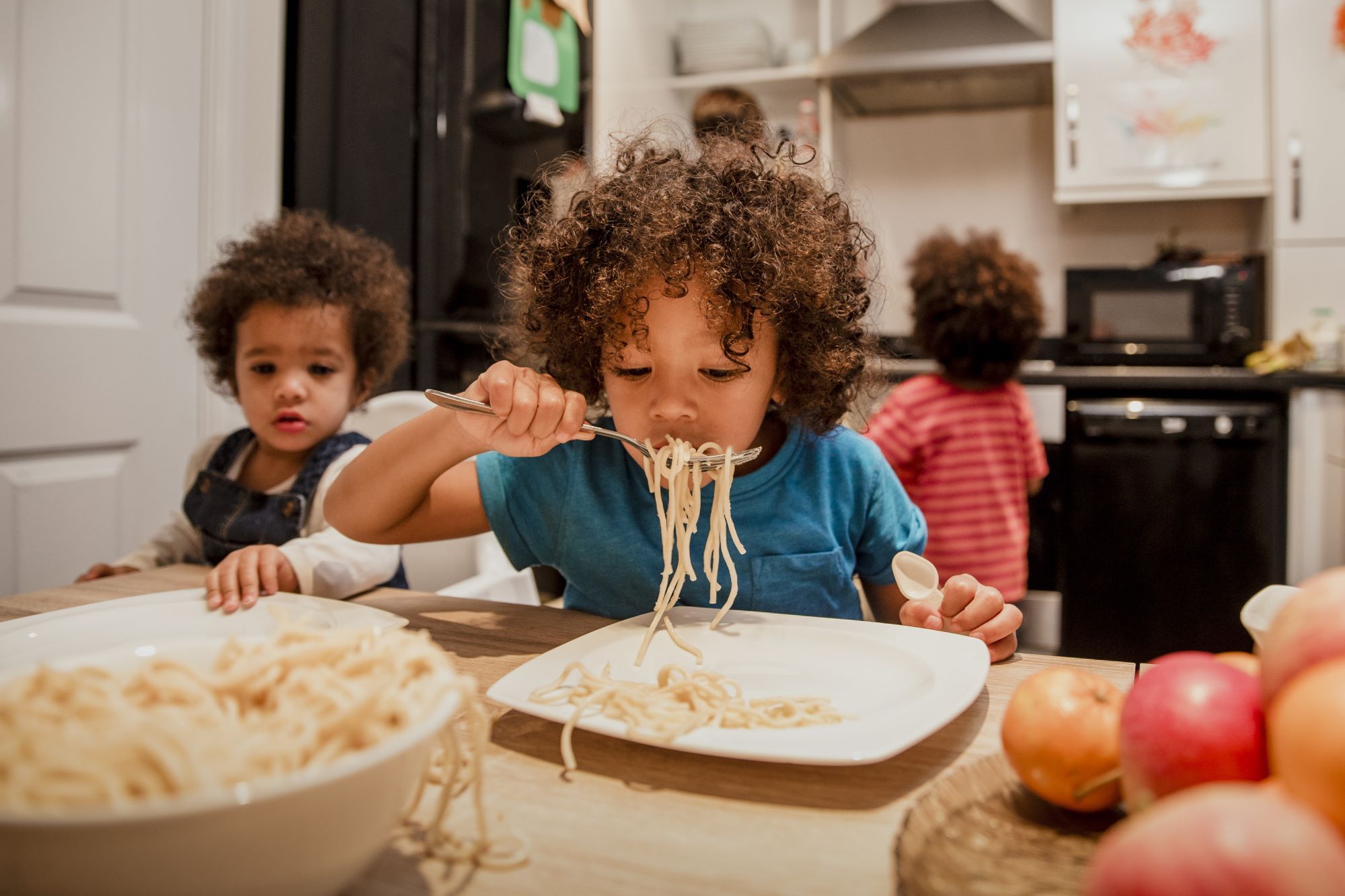 Little boy eating spaghetti