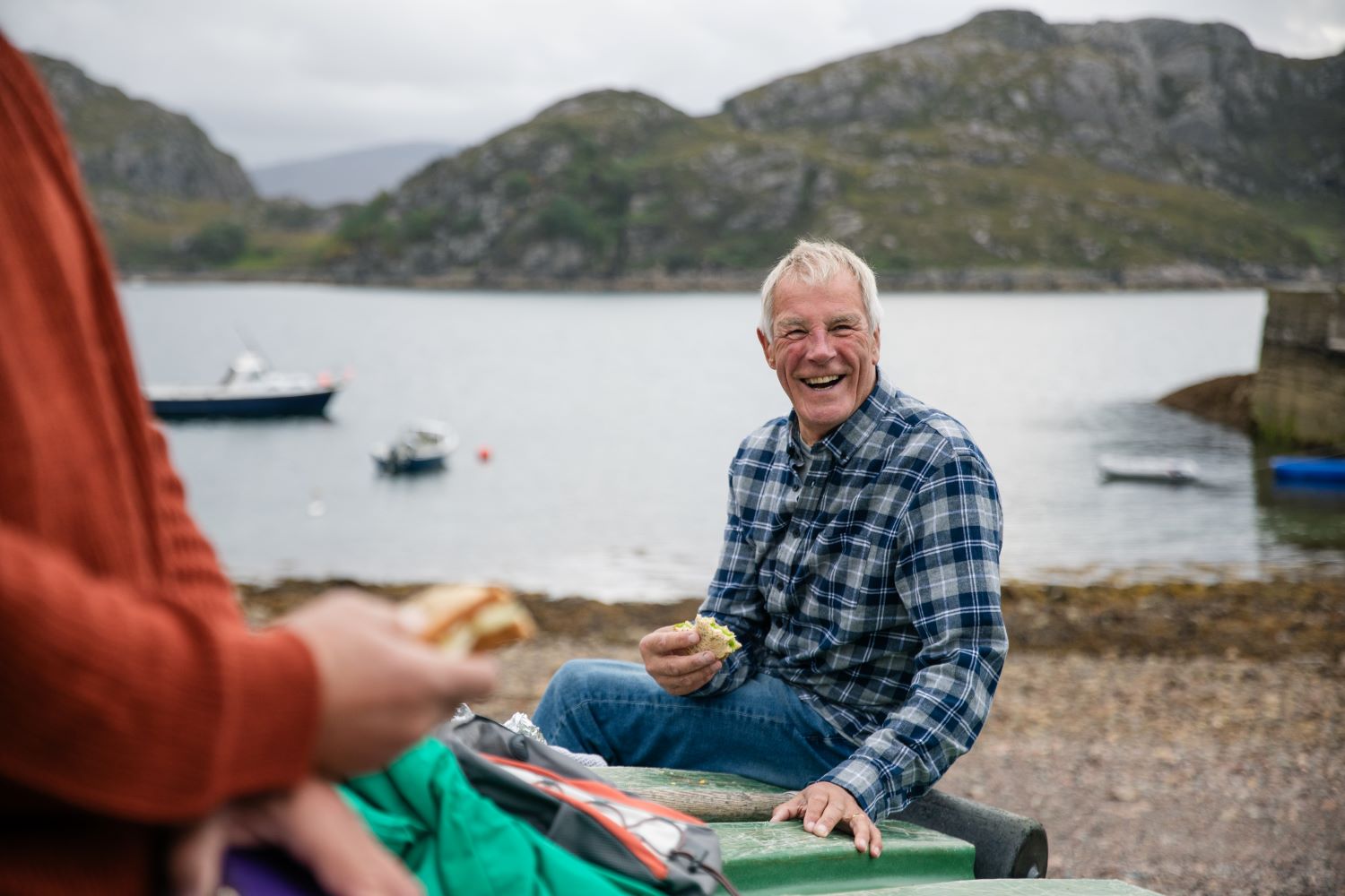 Man eating a sandwich on the beach