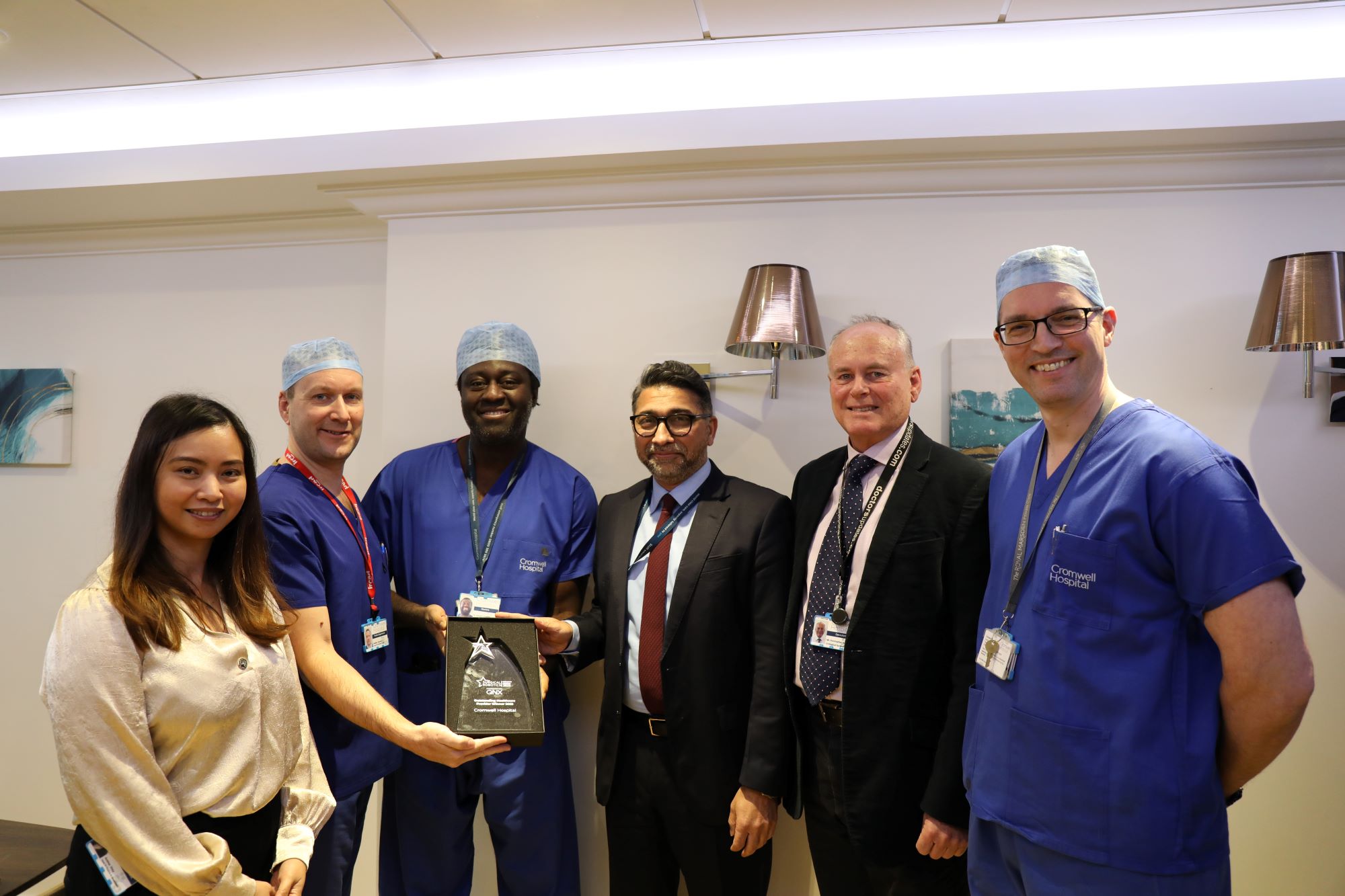 Cromwell Hospital team holding award for robotic surgery; ?>