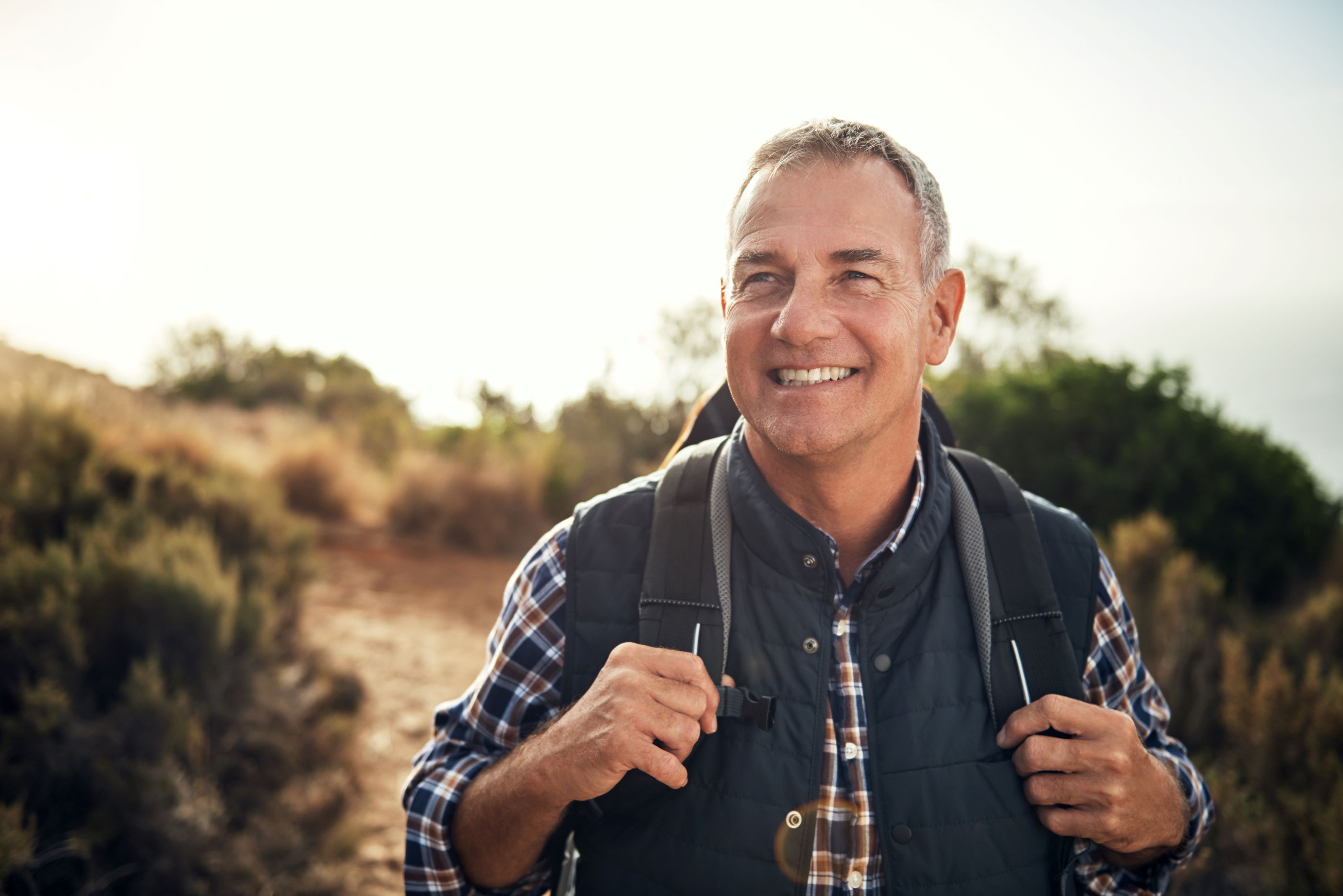 Picture of a smiling older man hiking