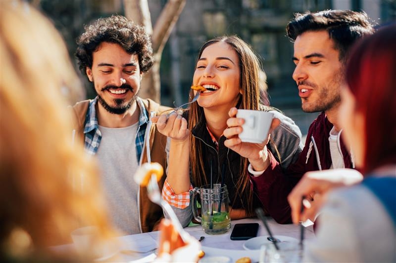 A picture of young people eating during a social gathering