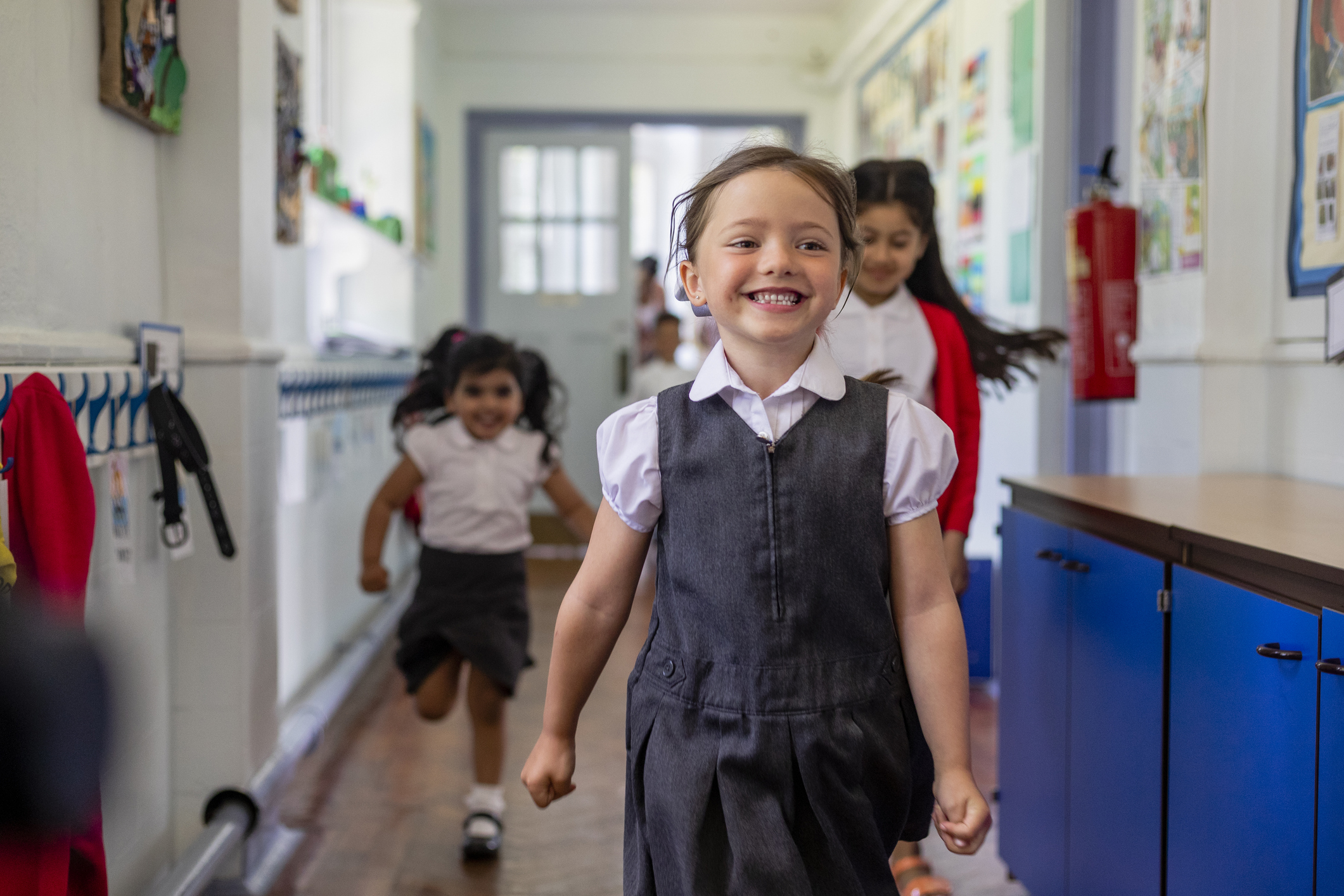 A school girl running down the school's corridor